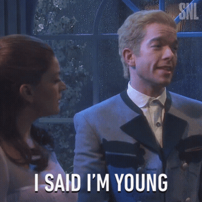 Man In Suit Says I Said I'm Young In Front Of Woman GIF