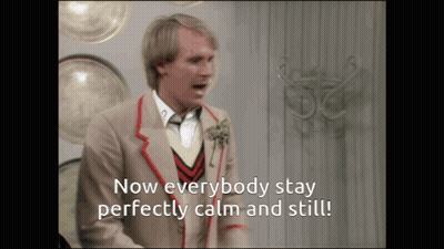Man In Suit Says Now Everybody Stay Perfectly Calm And Still GIF