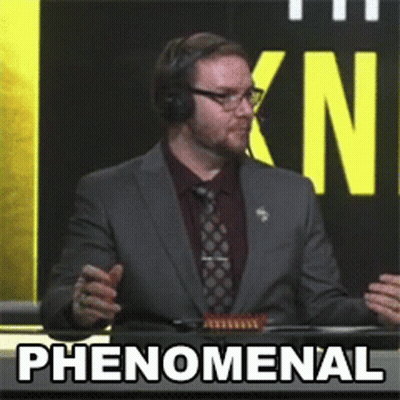 Man In Suit Says Phenomenal In Front Of KN Sign GIF