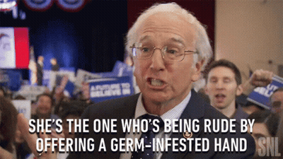 Man In Suit Says She's The One Being Rude By Offering A Germ GIF
