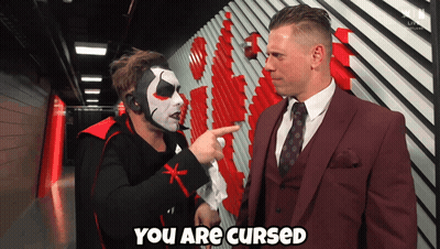 Man In Suit Says You Are Cursed To Masked Man GIF