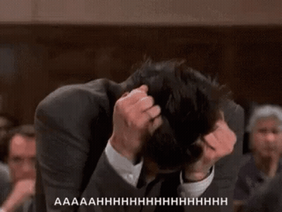 Man In Suit Scratching Head In Crowd GIF