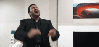 Man In Suit Screaming In Living Room With Volcano GIF