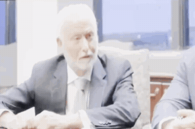 Man In Suit Shaking Hands At Table GIF