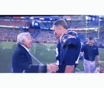 Man In Suit Shaking Hands With Man In Patriots Jersey GIF