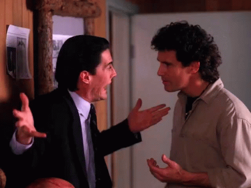 Man In Suit Shouting At Tan Shirt GIF