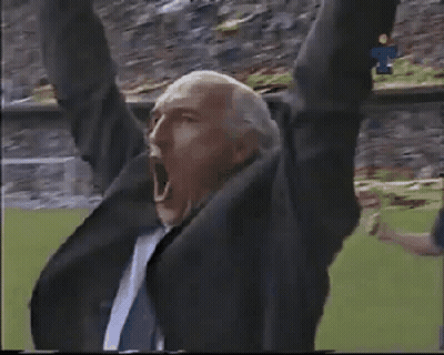 Man In Suit Shouting In Stadium GIF