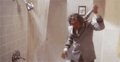 Man In Suit Showering Holding Bat GIF