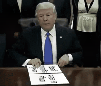Man In Suit Signing Document At Desk GIF