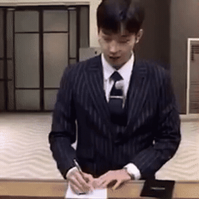 Man In Suit Signing Paper With Pen GIF