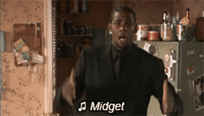 Man In Suit Singing In Front Of Refrigerator GIF