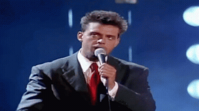 Man In Suit Singing Into Microphone GIF