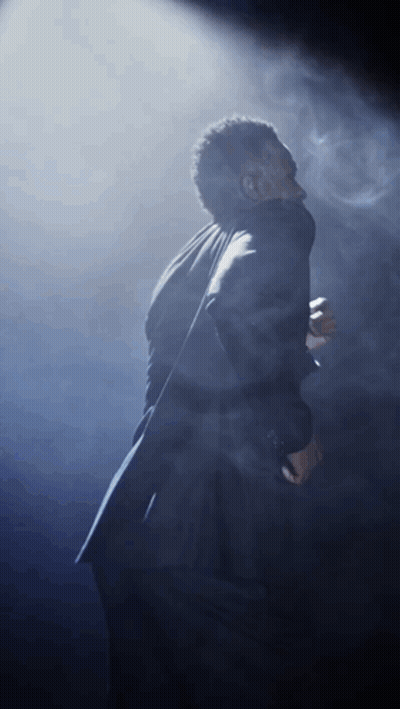 Man In Suit Singing Into Microphone GIF
