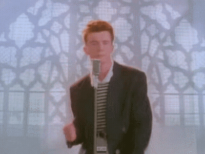 Man In Suit Singing Into Microphone In Front Of Stained Glass Window GIF