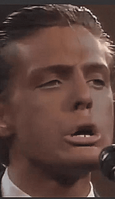 Man In Suit Singing Into Microphone Making Funny Face GIF