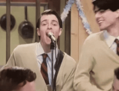 Man In Suit Singing Into Microphone Next To Another Man GIF