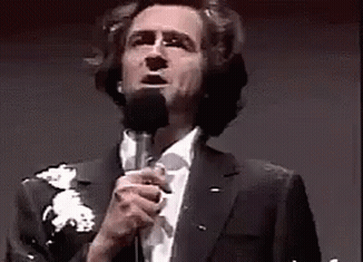 Man In Suit Singing Into Microphone GIF