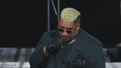 Man In Suit Singing Into Microphone Saying Pew GIF