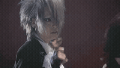 Man In Suit Singing Into Microphone With Gloves GIF
