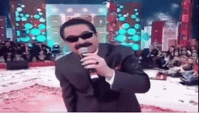 Man In Suit Singing Into Microphone With Sunglasses GIF