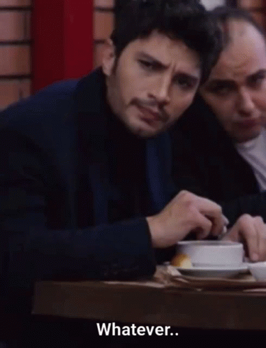 Man In Suit Sits At Table Says Whatever GIF