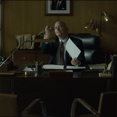 Man In Suit Sitting At Desk GIF