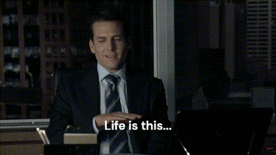 Man In Suit Sitting At Desk Arms Outstretched Saying I Like This GIF