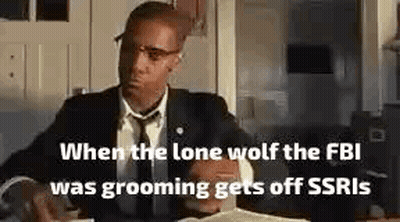 Man In Suit Sitting At Desk In Kitchen GIF