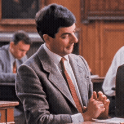 Man In Suit Sitting At Desk GIF