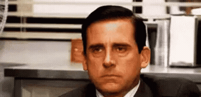Man In Suit Sitting At Desk GIF