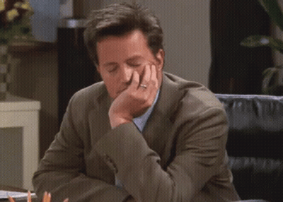 Man In Suit Sitting At Desk GIF