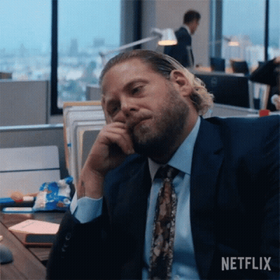 Man In Suit Sitting At Desk GIF