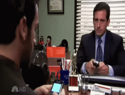 Man In Suit Sitting At Desk Talking On Cell Phone GIF