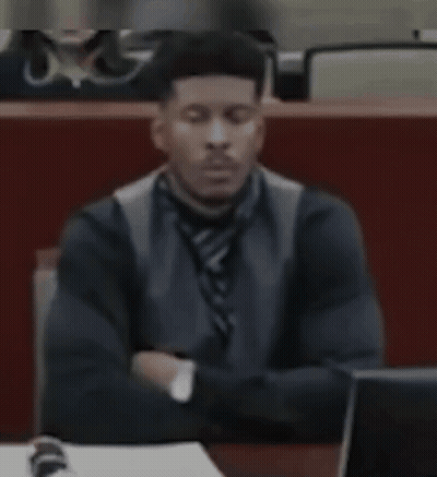 Man In Suit Sitting At Desk With Eyes Closed GIF