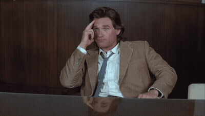 Man In Suit Sitting At Desk With Hand On Forehead GIF