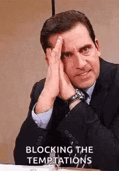 Man In Suit Sitting At Desk With Hands On Face GIF