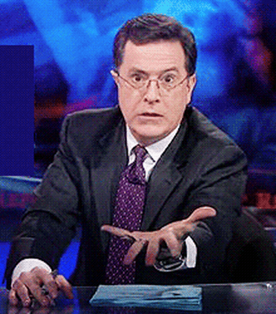 Man In Suit Sitting At Desk With Hands Out GIF