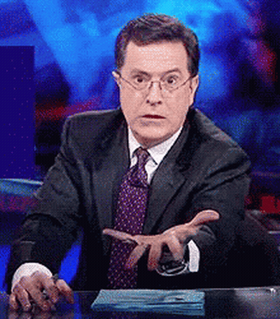Man In Suit Sitting At Desk With Hands Outstretched GIF