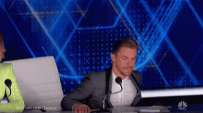 Man In Suit Sitting At Desk With Microphone GIF