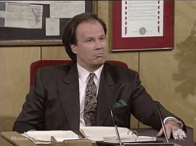 Man In Suit Sitting At Desk With Microphone GIF