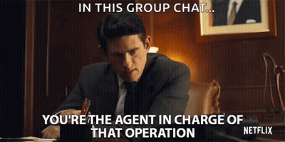 Man In Suit Sitting At Desk With Netflix Logo GIF