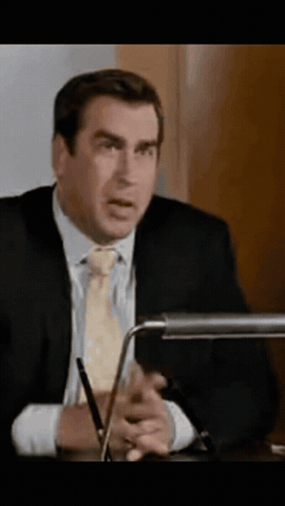 Man In Suit Sitting At Desk With Pen GIF