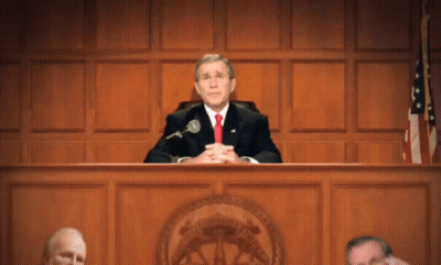 Man In Suit Sitting At Microphone GIF