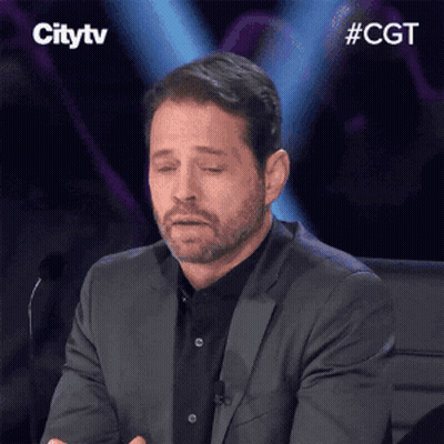Man In Suit Sitting At Microphone Eyes Closed GIF