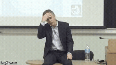Man In Suit Sitting At Projector Screen GIF