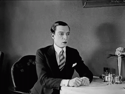 Man In Suit Sitting At Restaurant Table GIF