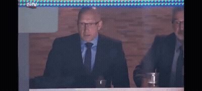 Man In Suit Sitting At Table GIF