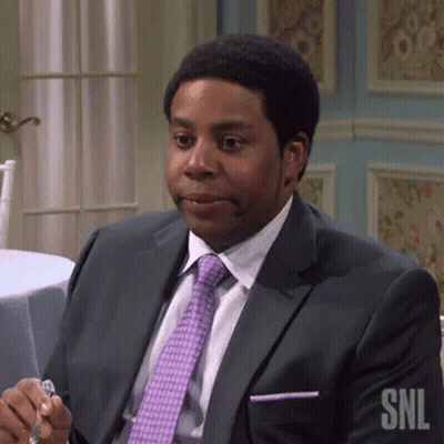Man In Suit Sitting At Table Holding Glass GIF