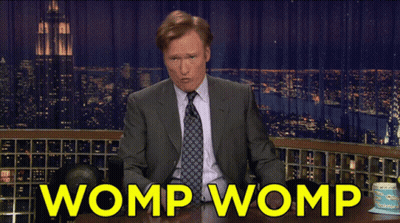 Man In Suit Sitting At Table Saying Womp Womp GIF