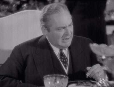 Man In Suit Sitting At Table With Bowl Of Food GIF